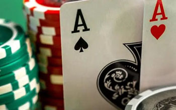 Live poker tournament with players seated around a table in BC